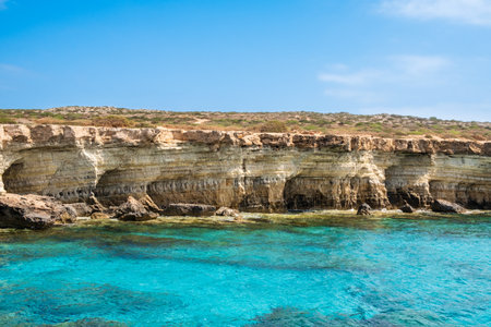 Sea caves near Ayia Napa in Cyprus. Natural rock formation famouse for cliff jumping into clear water. Dramatic coastline between Agia Napa and Cavo Greco National parkの写真素材