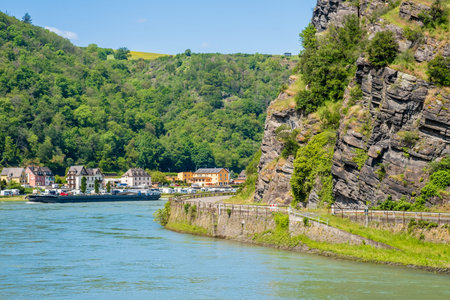 Lorelei rock on bank of Rhine river near Sankt Goarshausen town in Rhineland-Palatinate, Germany....