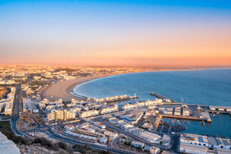 Agadir, Morocco at sunset. Panoramic view of Agadir city and bay in southern Morocco with Marina, beach and ocean from Oufla or Casbah fortress. Moroccan seaside resort on Atlantic coast in Africa.の写真素材