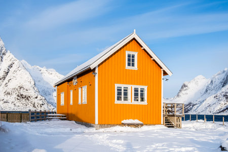 Traditional yellow rorbu house in Sakrisoy fishing village on Lofoten islands, Norway. Winter...