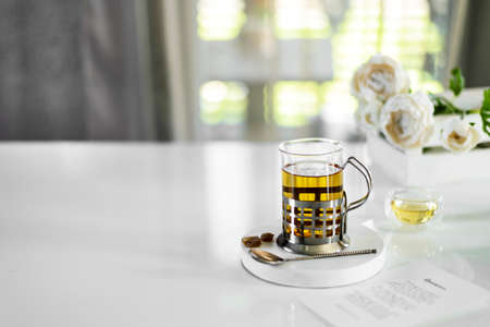 a transparent cup of tea on the tableの写真素材