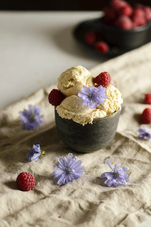 ice cream in a ceramic bowl with raspberriesの写真素材