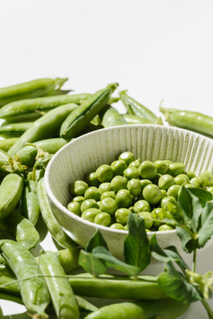 green peas and pods on a white background