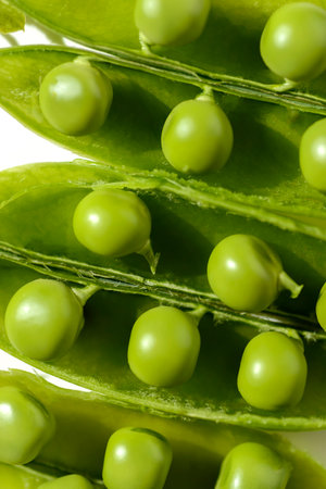 green peas and pods on a white backgroundの写真素材