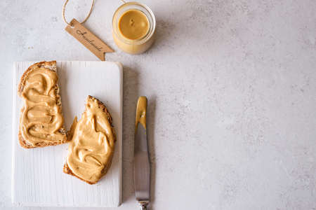 bread with peanut butter on the backgroundの写真素材