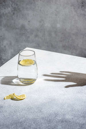 water with lemon on a gray background. high quality photoの写真素材