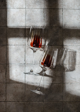 a glass of red wine on a gray background