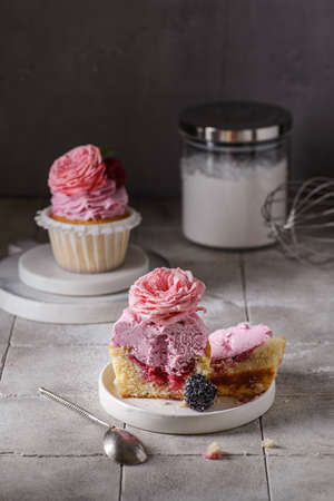 cupcakes with pink buttercream and roseの写真素材