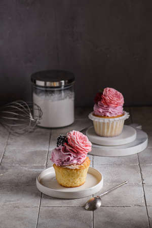 cupcakes with pink buttercream and roseの写真素材