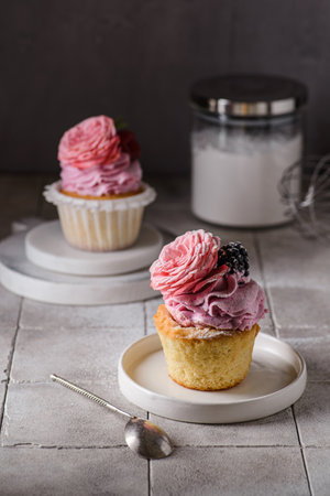 cupcakes with pink buttercream and roseの写真素材