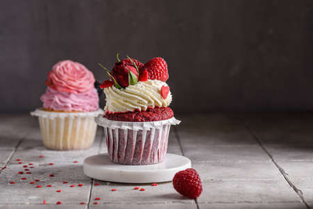 red velvet cupcake with raspberries and creamの写真素材