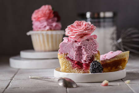 cupcakes with pink buttercream and roseの写真素材
