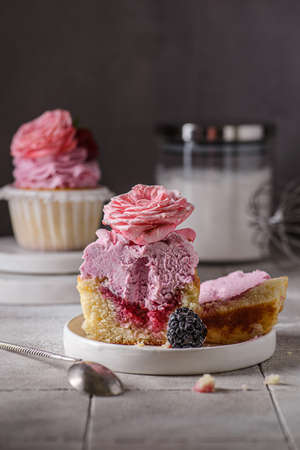 cupcakes with pink buttercream and roseの写真素材