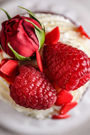 red velvet cupcake with raspberries and creamの写真素材