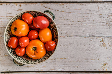 tomatoes are yellow and red on a light background. high quality photo