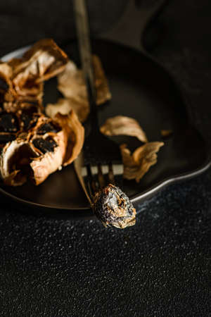 fermented black garlic on the background. high quality photoの写真素材