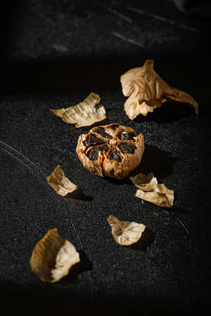 fermented black garlic on the background. high quality photoの写真素材