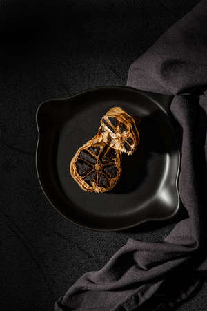 fermented black garlic on the background. high quality photoの写真素材