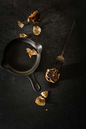 fermented black garlic on the background. high quality photoの写真素材
