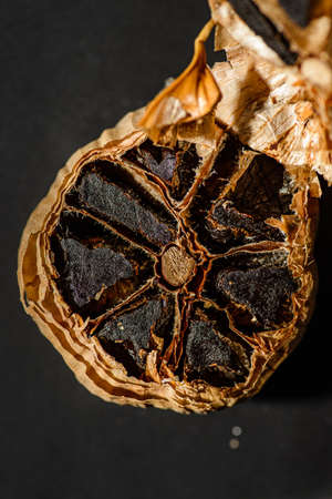 fermented black garlic on the background. high quality photoの写真素材