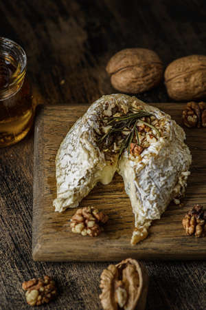 baked brie cheese on a wooden board. high quality photoの写真素材