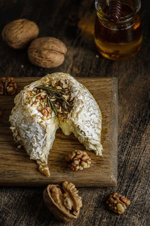 baked brie cheese on a wooden board. high quality photoの写真素材