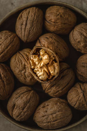 walnuts in a shell in a bowlの写真素材