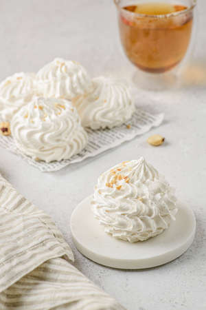 meringue cake with tea on a white parchment. meringue is a dessert made of whipped egg whites with sugar.の写真素材