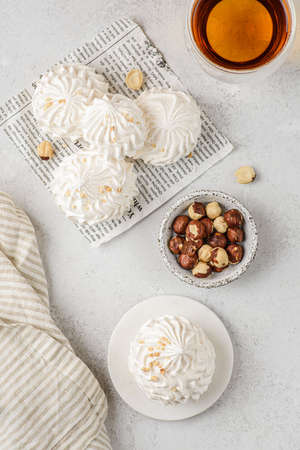 meringue cake with tea on a white parchment. meringue is a dessert made of whipped egg whites with sugar. top viewの写真素材