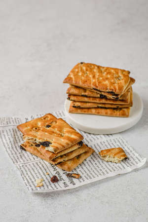 a stack of shortbread cookies with raisins on a white background with the towel. copy spaceの写真素材