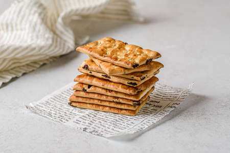 a stack of shortbread cookies with raisins on a white background with the towel.の写真素材