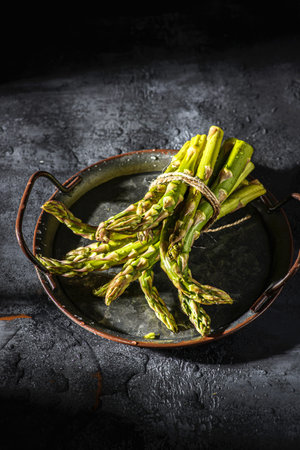 a bunch of asparagus on a metal tray. high quality photoの写真素材