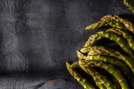 asparagus is laid out on a dark backgroundの写真素材