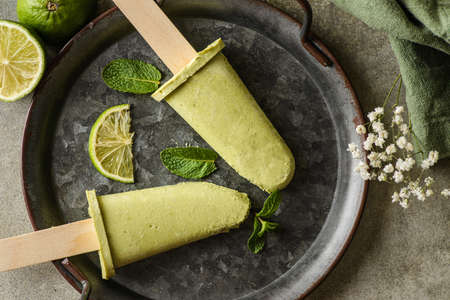 Vegan avocado ice cream with lime juice and coconut milk is on a metal tray, flatlay topviewの写真素材