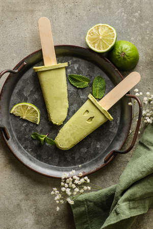Vegan avocado ice cream with lime juice and coconut milk is on a metal tray, flatlay topviewの写真素材