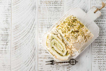 Swiss meringue roll from egg whites and sugar with pistachio, mascarpone.の写真素材