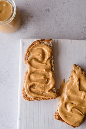 bread with peanut butter on the background. high quality photo