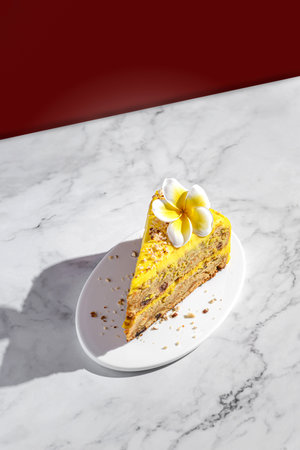 a piece of carrot cake with cream, a colored background on the back, decorated with a flower