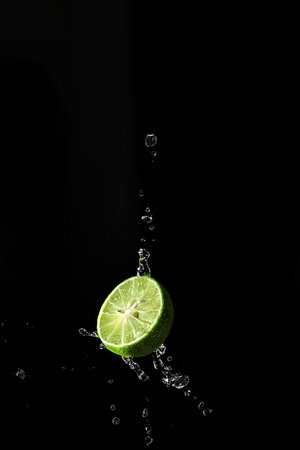 lime splashes on a black background. high quality photoの写真素材