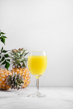 pineapple juice in a glass on a light table. high quality photoの写真素材