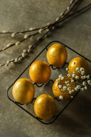 painted golden eggs for easter on green background. high quality photoの写真素材