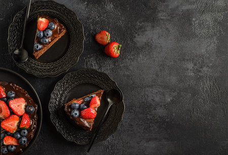 chocolate cake with protein decorated with berries on dark background, chocolate cake decorated with berries. high quality photoの写真素材