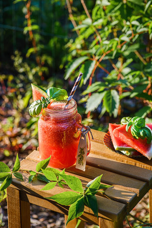 watermelon smoothie on a wooden table outside. high quality photoの写真素材
