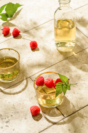 the cocktail is decorated with raspberries. high quality photoの写真素材