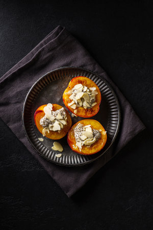 grilled peaches with yogurt and honey, chia and almond petals. High quality photoの写真素材