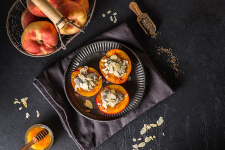 grilled peaches with yogurt and honey, chia and almond petals. High quality photoの写真素材