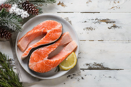 raw salmon steaks with fir branches and conesの写真素材