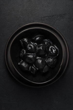 black dumplings in a black bowl. High quality photoの写真素材