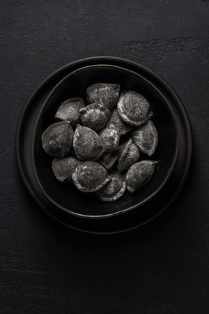 black dumplings in a black bowl. High quality photoの写真素材