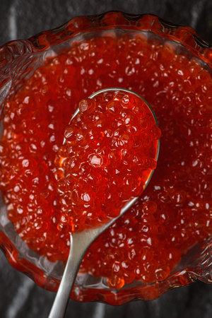 red caviar on a black background. High quality photoの写真素材